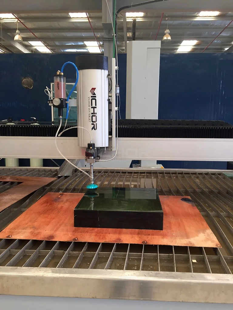 Cutting head over a dark glass panel